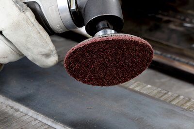 Surface conditioning products have a non-woven construction in which fiber strands, resin, and abrasive mineral form a thick, open web or mesh.