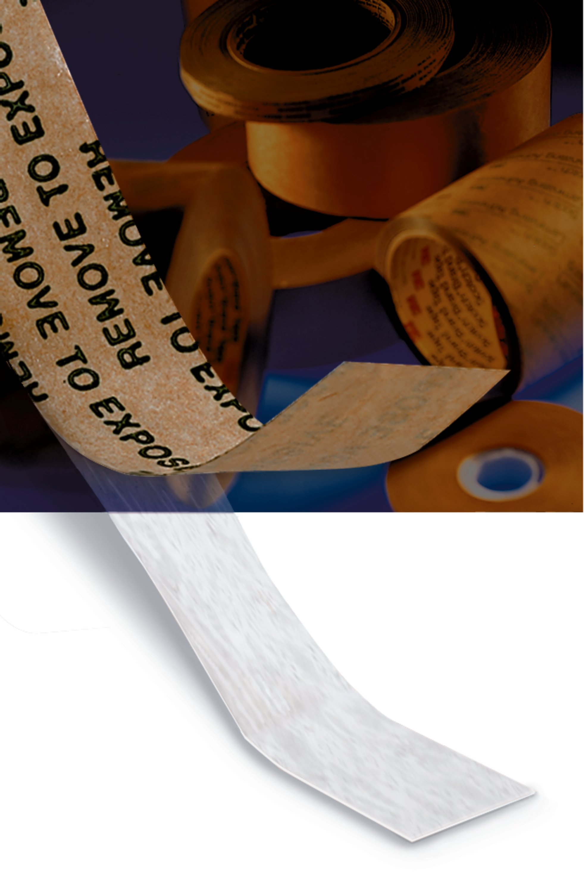 Adhesive transfer tape being pulled away from its brown liner