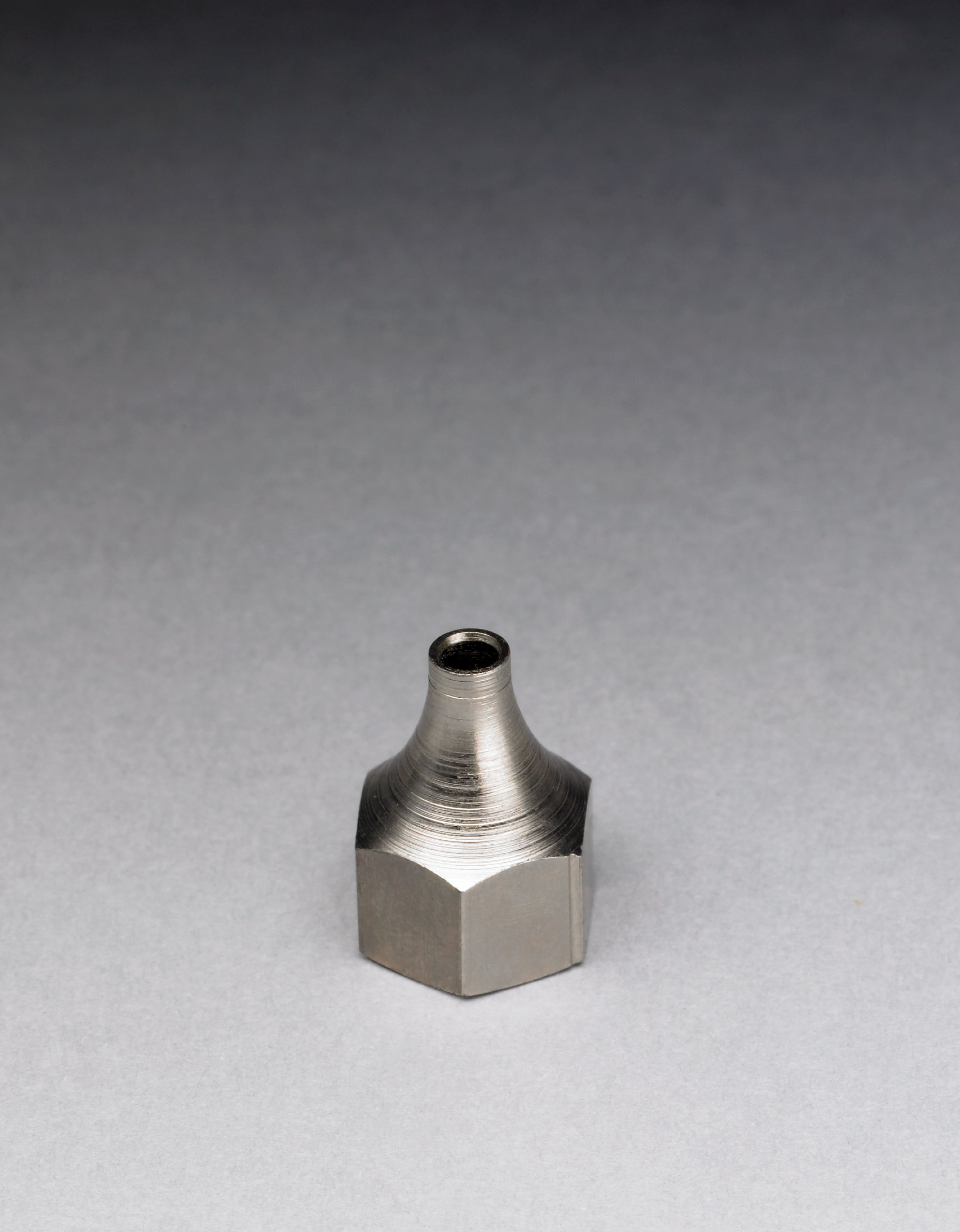 A fluted (0.125") metal tip designed for use with high viscosity hot melts.