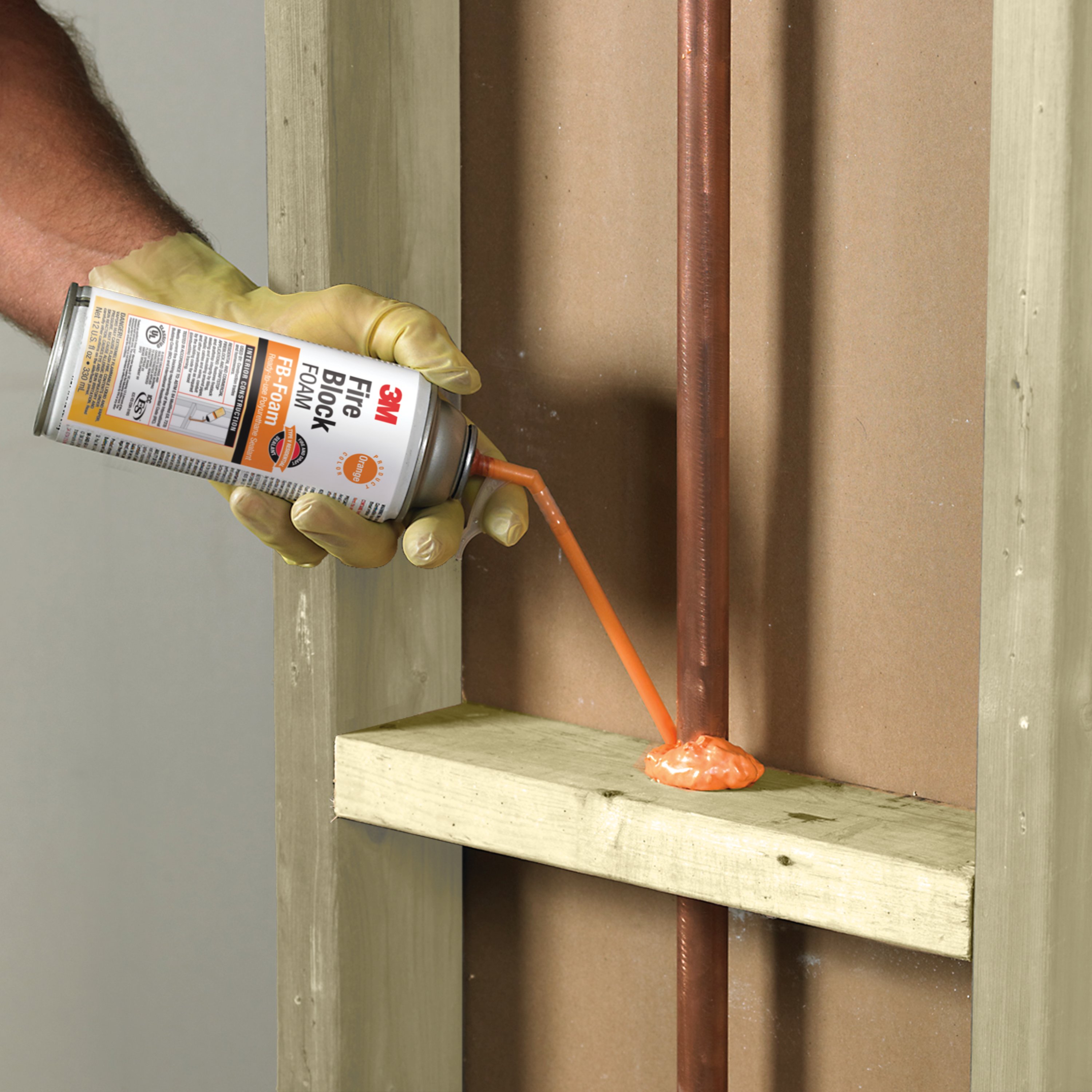 3M™ Fire Block Foam FB-Foam application insulating copper pipe going through wood framework in wall