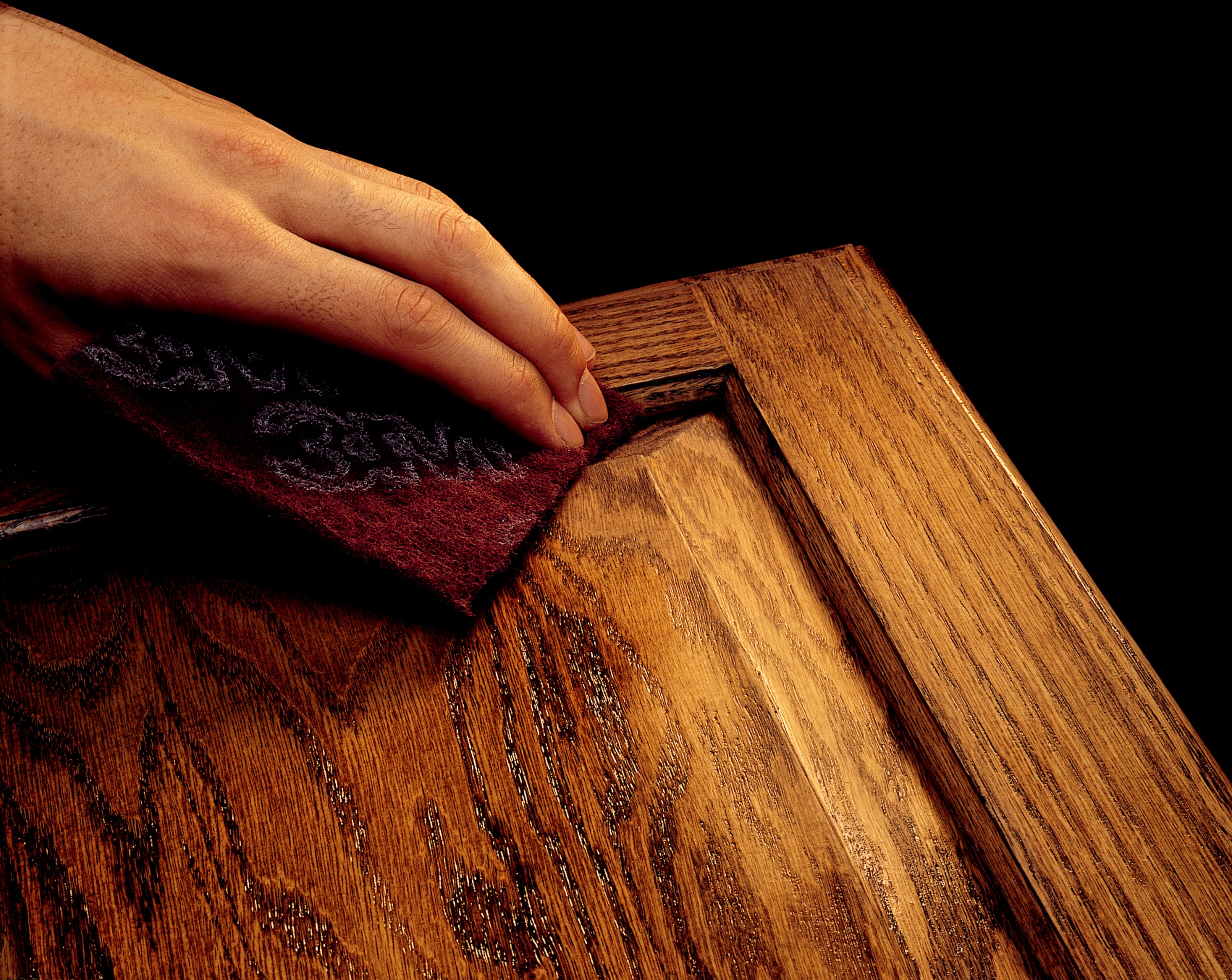 This maroon hand pad uses aluminum oxide abrasive.